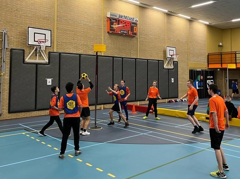 Jongeren met een basketbal in een sporthal